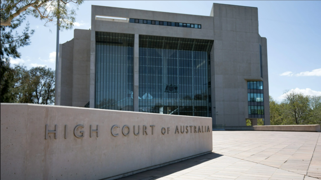Canberra, Australia - March 10, 2020: Ground-level external view of the High Court of Australia building, characterised by a large, inscribed granite sign on the site